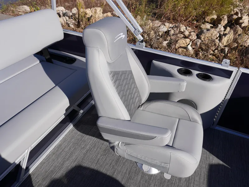 Slide: The Image of 2025 Bennington 20 SSB boat interior with gray captain's chair and cup holders. - 7