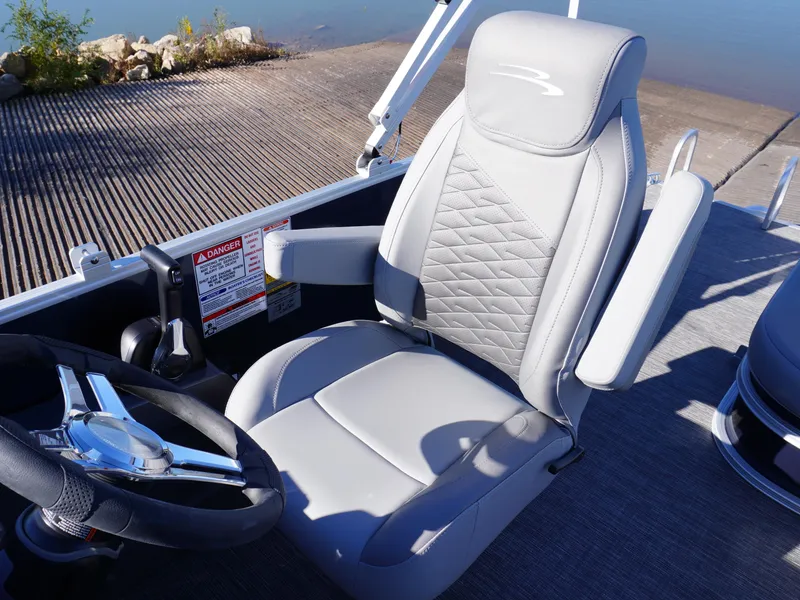 Slide: The Image of 2025 Bennington 20 SSB boat seat with steering wheel, featuring sleek gray upholstery. - 8