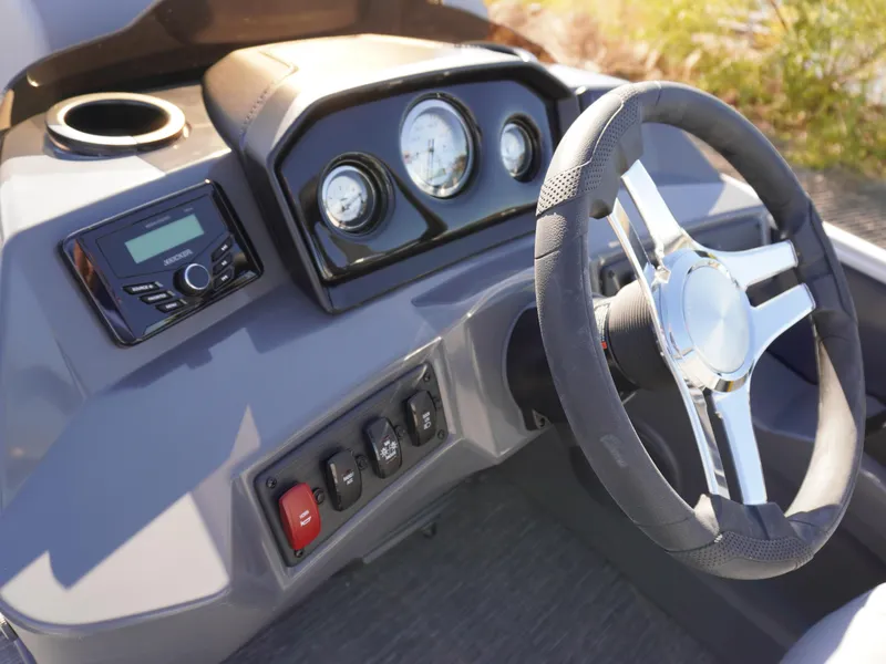 Slide: The Image of 2025 Bennington 20 SSB boat dashboard with steering wheel and control panel. - 9
