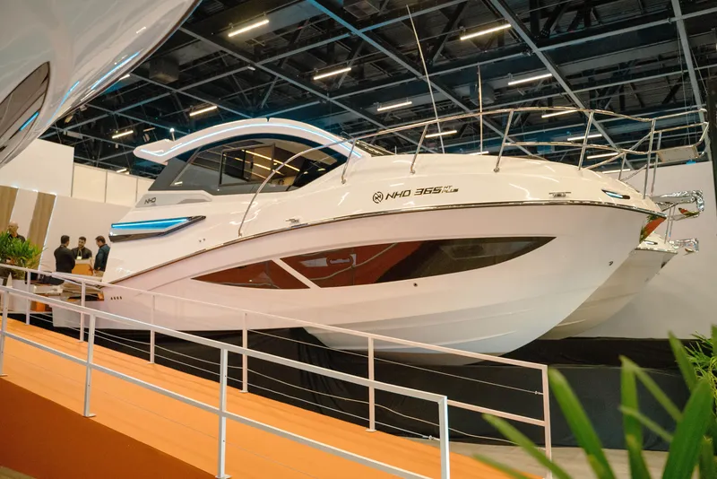 Slide: The Image of 2025 NHD 365 HT PLUS yacht displayed at a boat show, sleek design and modern features. - 1