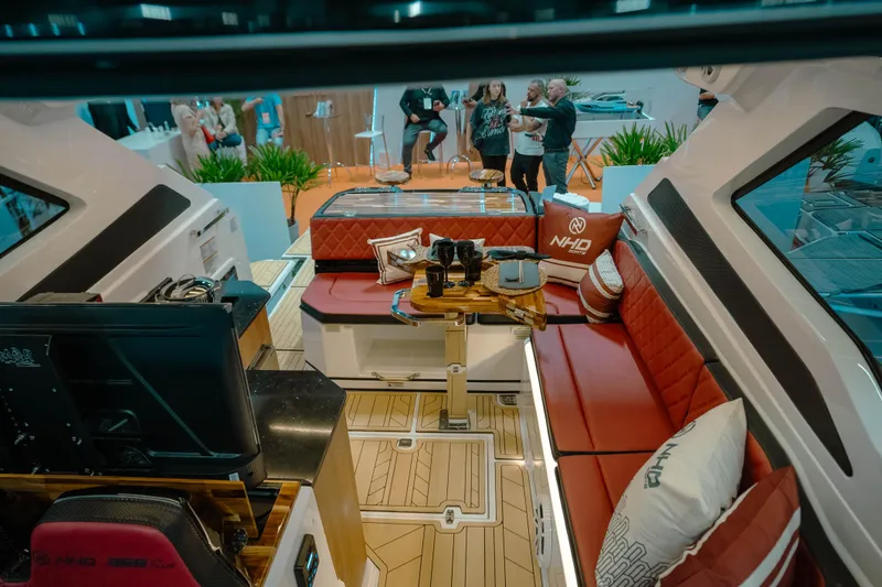 Slide: The Image of Luxurious interior of 2025 NHD 365 HT PLUS yacht with red seating and modern amenities. - 14
