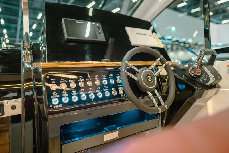 Slide: The Image of Control panel of 2025 NHD 365 HT PLUS boat with steering wheel and dashboard. - 19