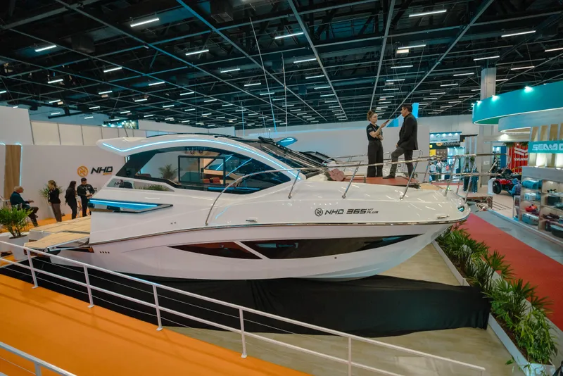 Slide: The Image of 2025 NHD 365 HT PLUS yacht displayed at a boat show, featuring sleek design and modern amenities. - 3