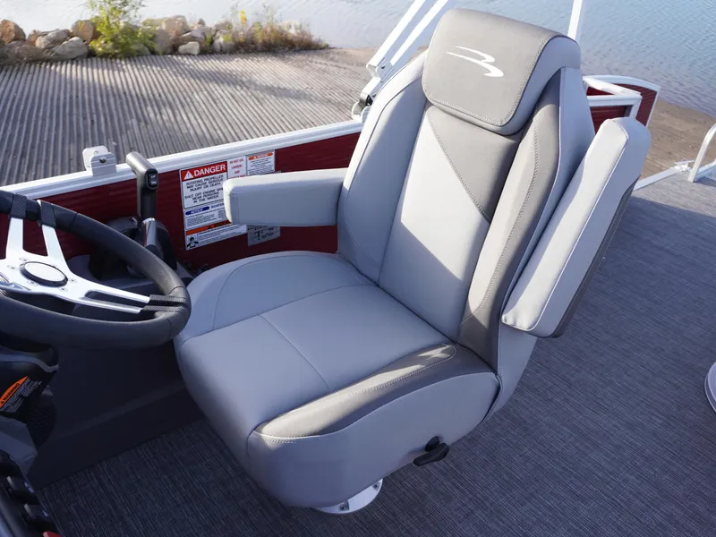 Slide: The Image of Captain's chair on 2025 Bennington 22 SVSB pontoon boat, featuring sleek gray upholstery. - 12
