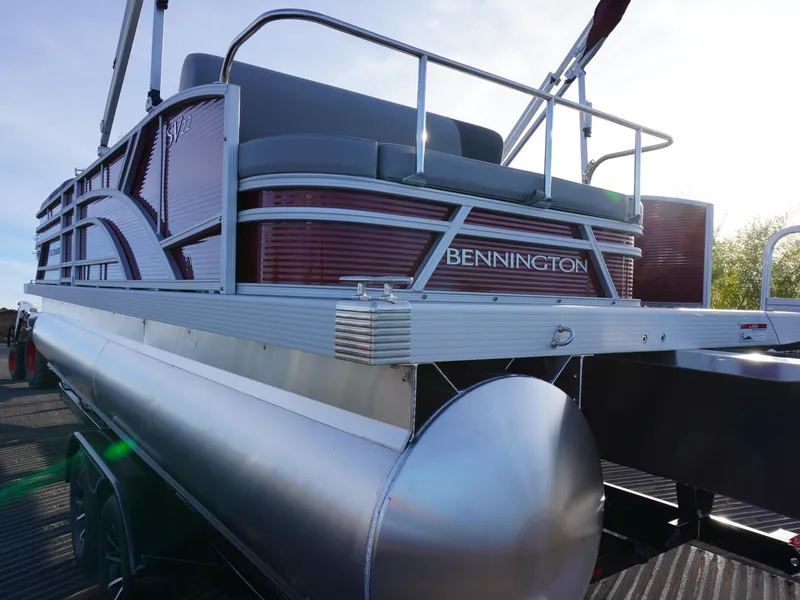 Slide: The Image of 2025 Bennington 22 SVSB pontoon boat, rear view, showcasing sleek design and modern features. - 4