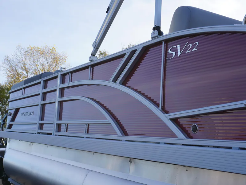 Slide: The Image of 2025 Bennington 22 SVSB pontoon boat with sleek maroon and gray design. - 5