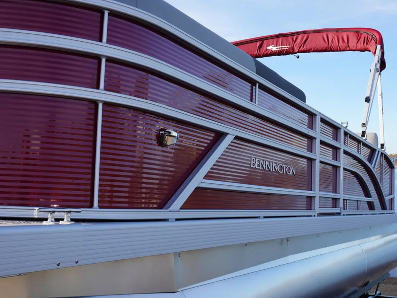 Slide: The Image of 2025 Bennington 22 SVSB pontoon boat with sleek red and silver design. - 6