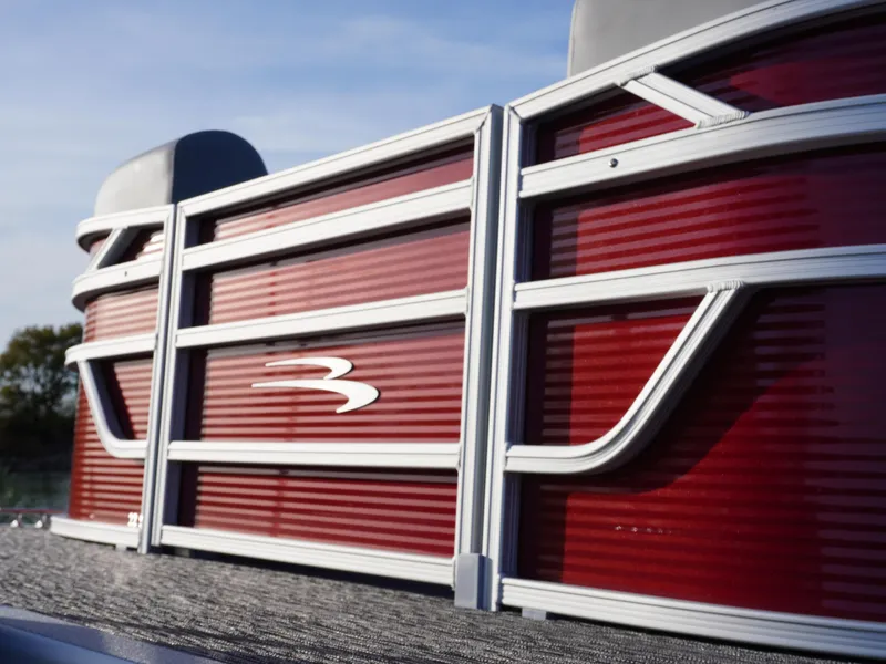 Slide: The Image of 2025 Bennington 22 SVSB pontoon boat with sleek red paneling and silver accents. - 7