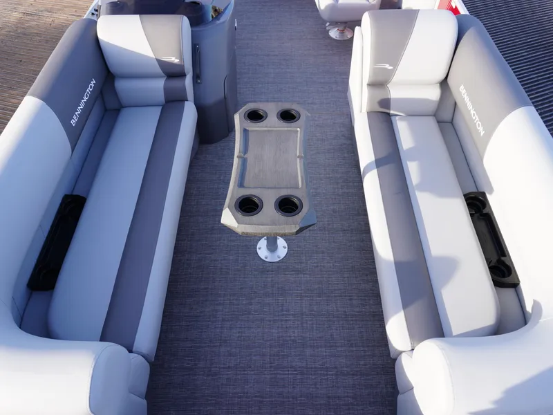 Slide: The Image of 2025 Bennington 22 SVSB boat interior with gray seating and central table. - 8