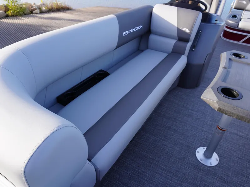 Slide: The Image of 2025 Bennington 22 SVSB boat interior with gray seating and cup holders. - 9