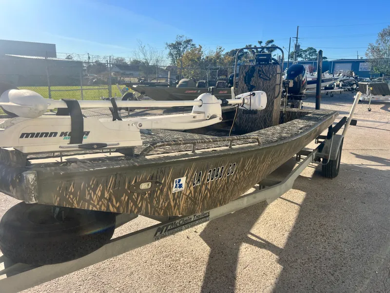 Slide: The Image of 2015 Gator Trax 18 boat with Minn Kota trolling motor on a trailer, parked outdoors. - 5