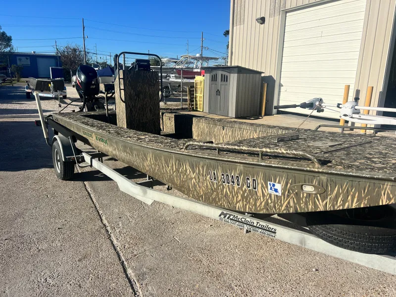 Slide: The Image of 2015 Gator Trax 18 boat on trailer, parked outdoors in sunny weather. - 7