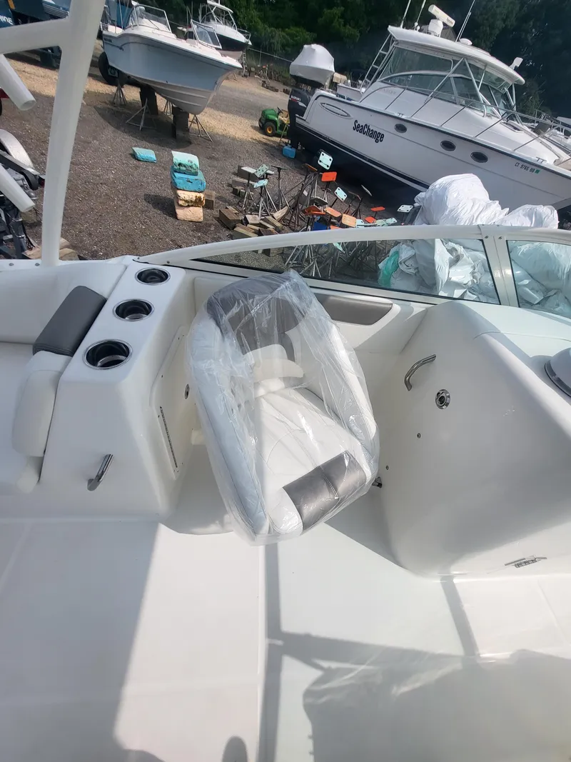 Slide: The Image of 2024 World Cat 230 SD boat interior with seating and cup holders. - 3