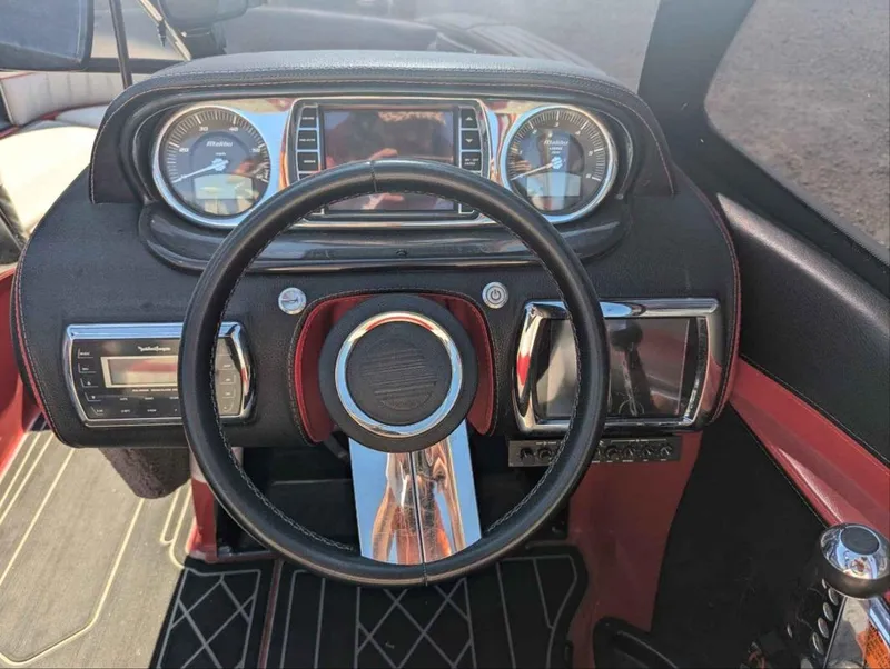 Slide: The Image of Dashboard of 2014 Malibu Wakesetter 22 MXZ boat with steering wheel and gauges. - 10