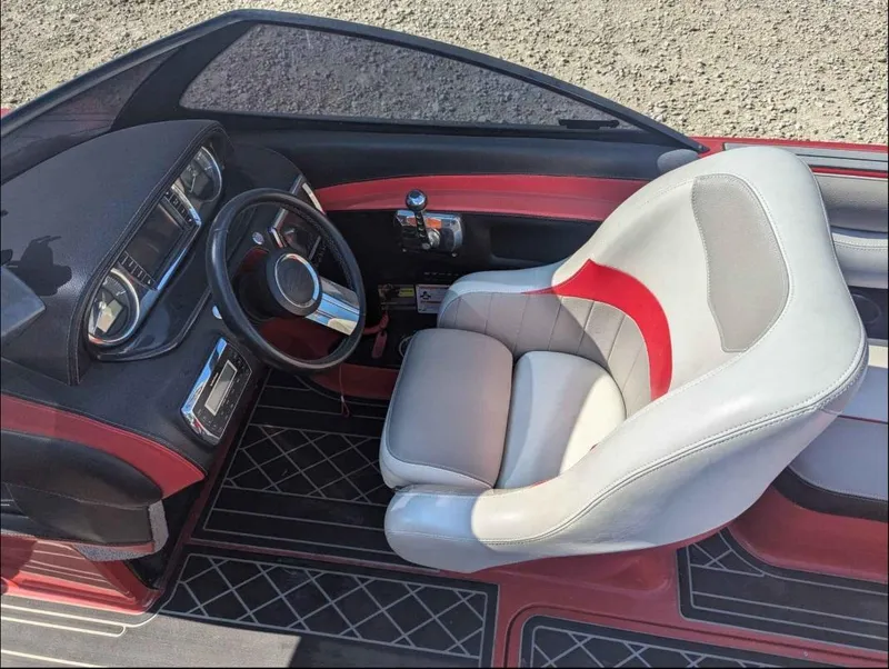 Slide: The Image of 2014 Malibu Wakesetter 22 MXZ interior with steering wheel and captain's chair. - 11