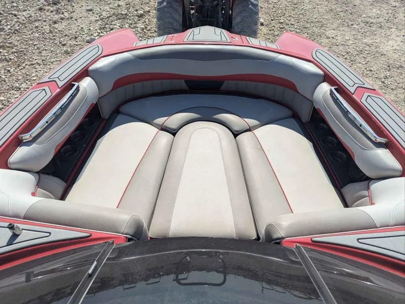 Slide: The Image of 2014 Malibu Wakesetter 22 MXZ boat interior with red and gray seating. - 12