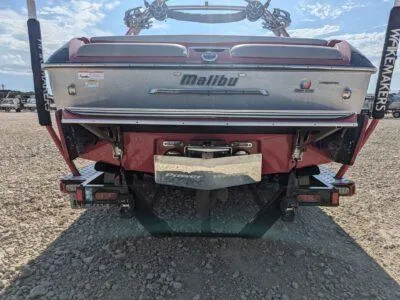 Slide: The Image of 2014 Malibu Wakesetter 22 MXZ boat rear view on gravel surface. - 9