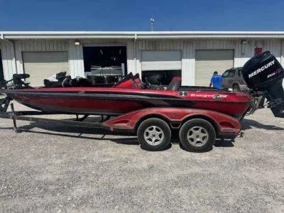 Slide: The Image of 2007 Ranger Z21 Comanche boat with Mercury engine on trailer, parked outside garage. - 1