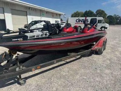 Slide: The Image of 2007 Ranger Z21 Comanche boat on trailer, red and black, parked outdoors. - 2