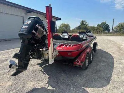 Slide: The Image of 2007 Ranger Z21 Comanche boat with Mercury engine, parked outdoors on gravel. - 4