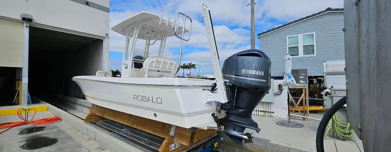 Slide: The Image of 2018 Robalo 246 Cayman boat with Yamaha engine on a dock. - 0