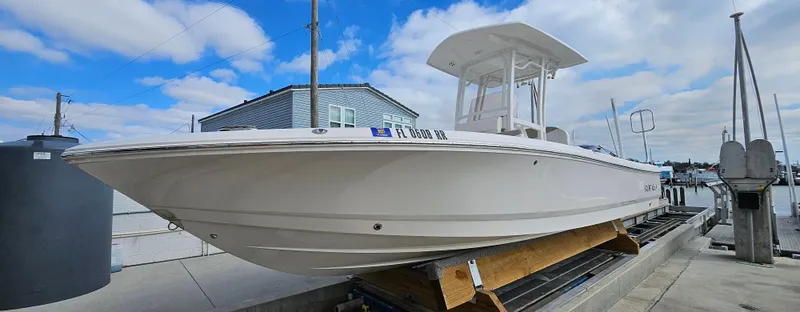 Slide: The Image of 2018 Robalo 246 Cayman boat docked under a cloudy sky. - 1