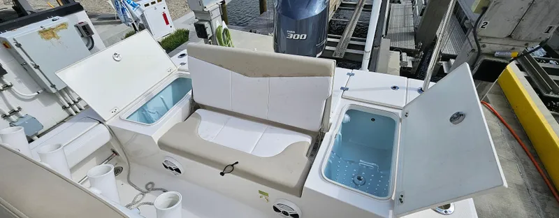 Slide: The Image of 2018 Robalo 246 Cayman boat interior with seating and storage compartments open. - 11