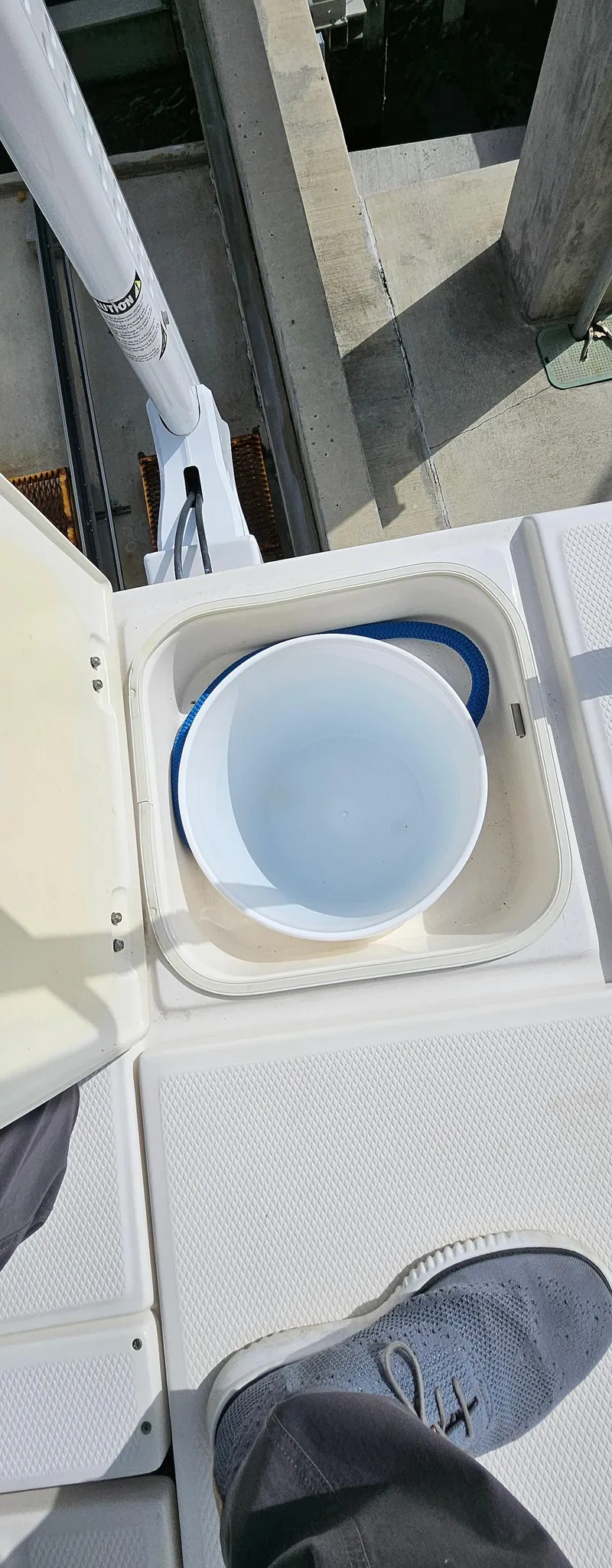 Slide: The Image of 2018 Robalo 246 Cayman boat deck with storage compartment and bucket. - 16