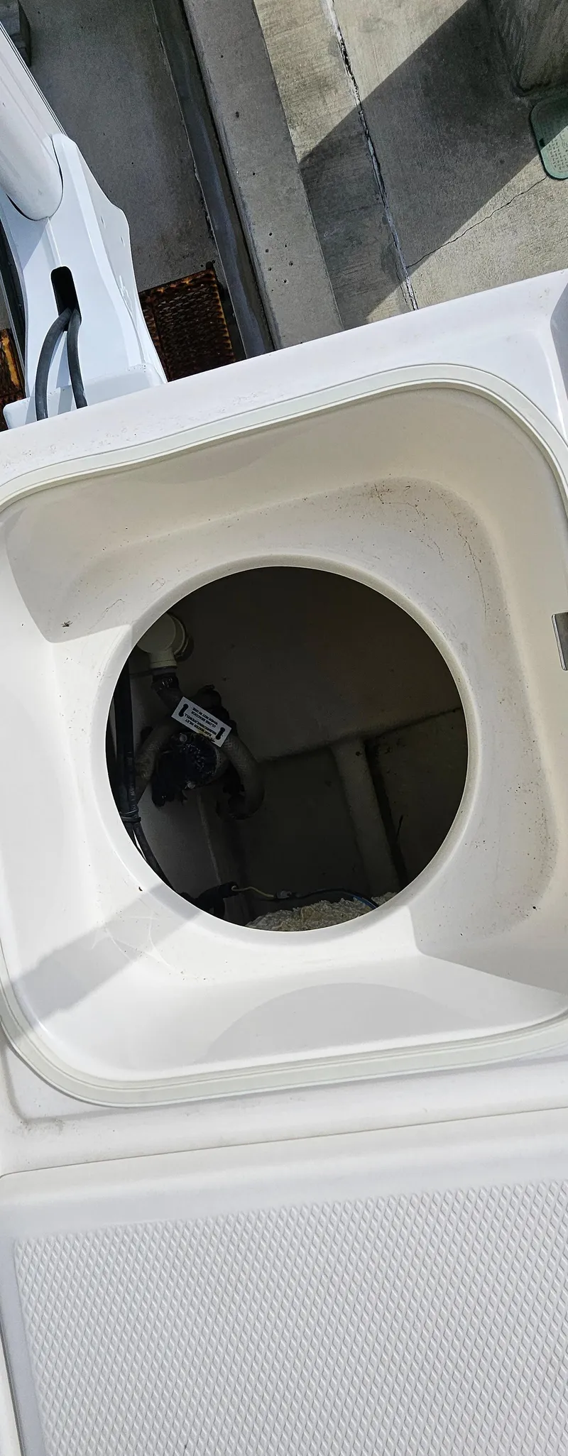 Slide: The Image of 2018 Robalo 246 Cayman boat storage compartment, open lid view. - 17