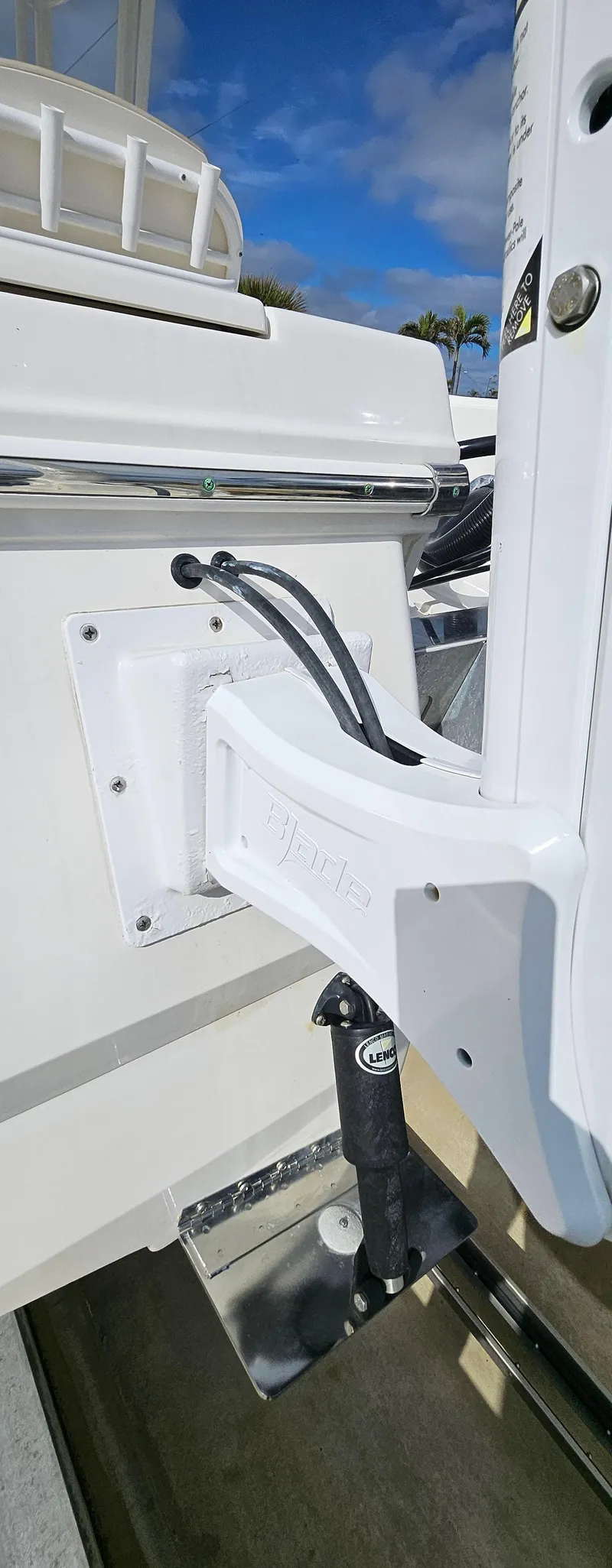 Slide: The Image of 2018 Robalo 246 Cayman boat detail, featuring a white hull and mounted equipment. - 19