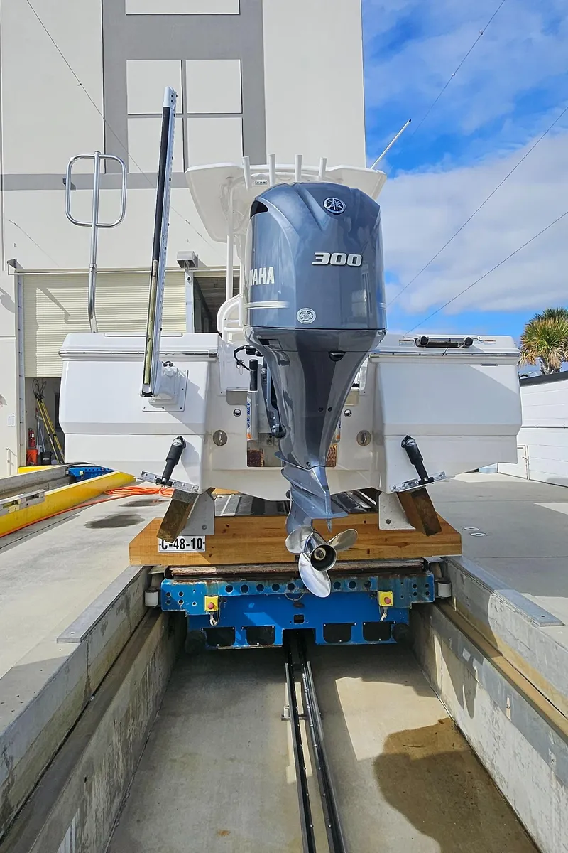 Slide: The Image of 2018 Robalo 246 Cayman boat with Yamaha 300 engine on a trailer. - 21