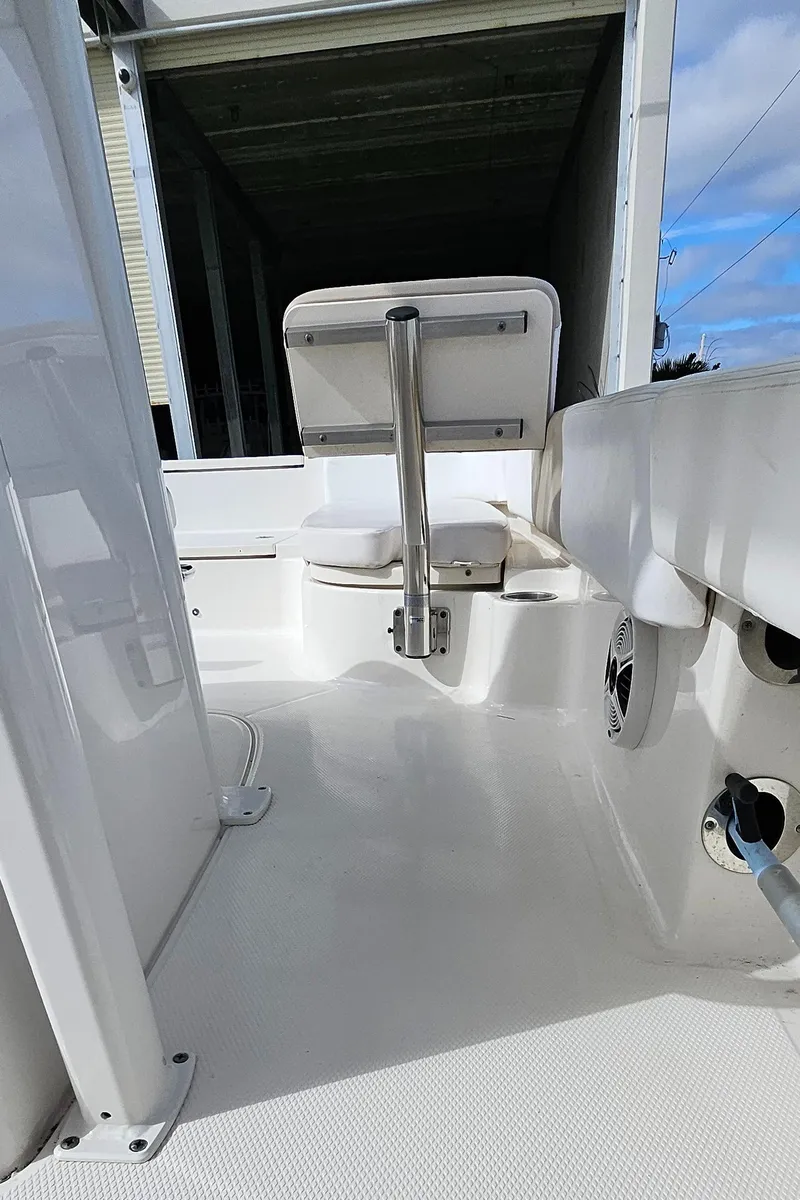 Slide: The Image of 2018 Robalo 246 Cayman boat interior, featuring seating and storage area. - 24