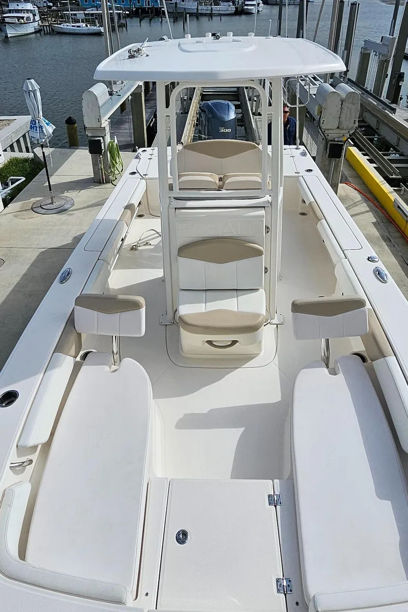 Slide: The Image of 2018 Robalo 246 Cayman boat docked, featuring spacious seating and center console. - 26