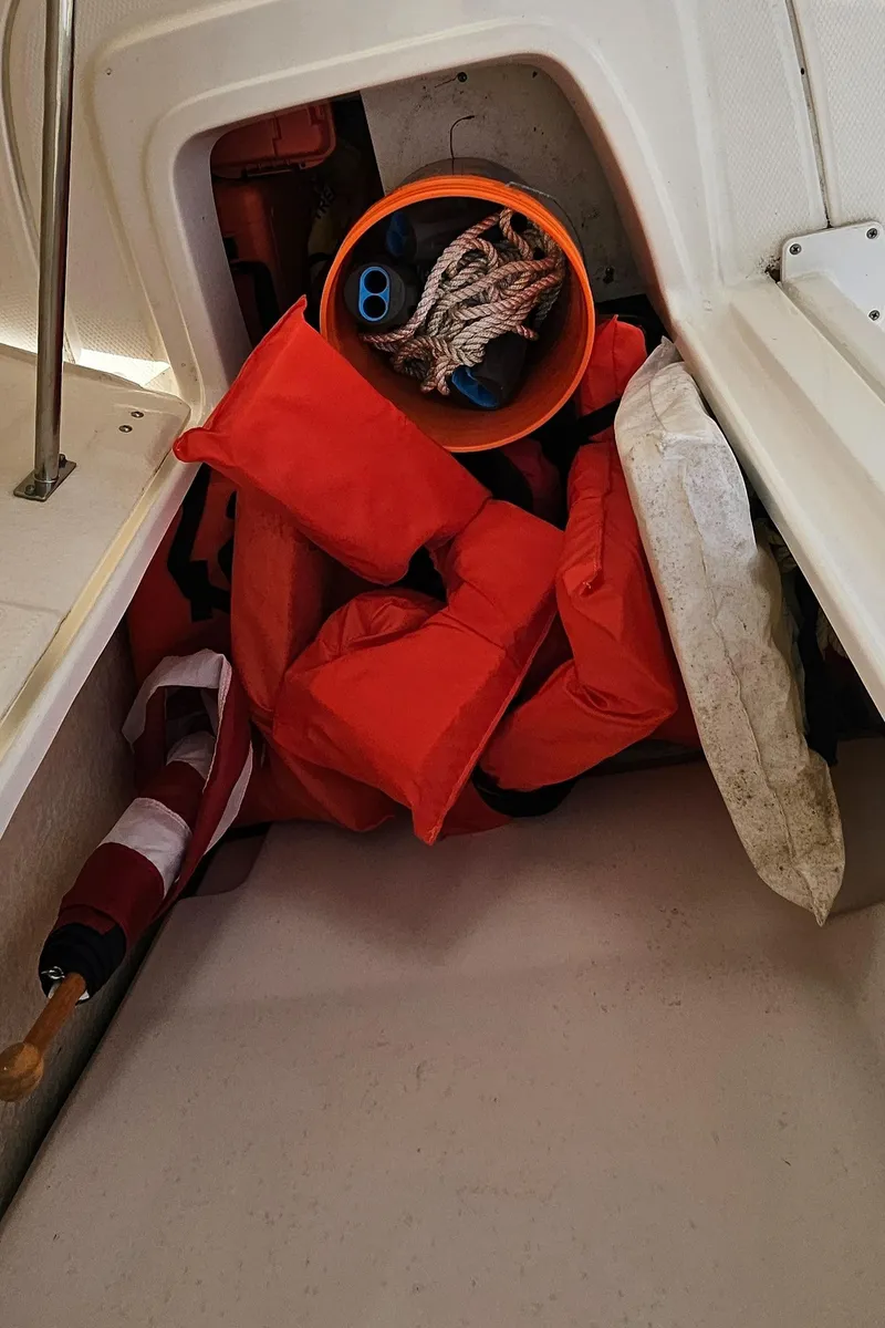 Slide: The Image of Storage compartment on a 2018 Robalo 246 Cayman boat with life jackets and ropes. - 28
