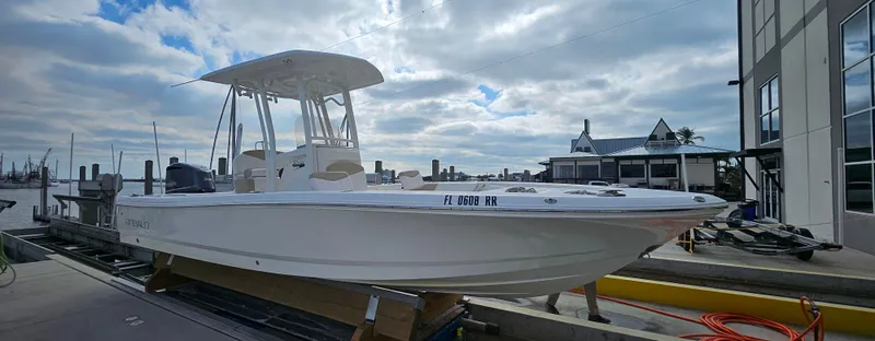 Slide: The Image of 2018 Robalo 246 Cayman boat docked under cloudy sky. - 4