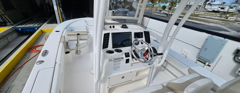 Slide: The Image of 2018 Robalo 246 Cayman boat interior with steering console and seating. - 5