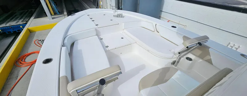 Slide: The Image of 2018 Robalo 246 Cayman boat interior with seating and storage compartments. - 8