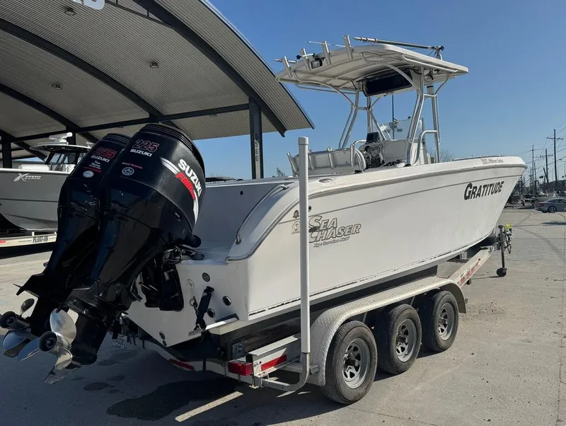 Slide: The Image of 2005 Sea Chaser 2600 CC boat on trailer with dual Suzuki outboard motors. - 14