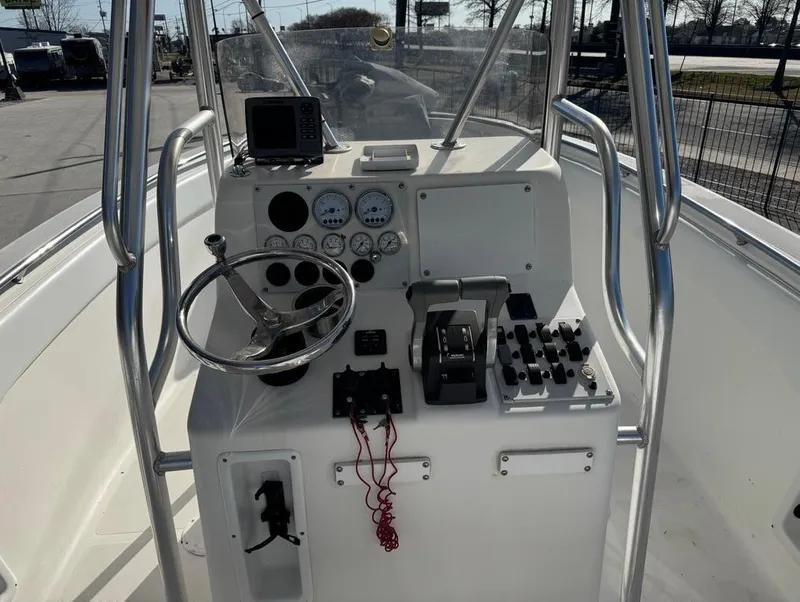 Slide: The Image of 2005 Sea Chaser 2600 CC boat console with steering wheel, gauges, and controls. - 3