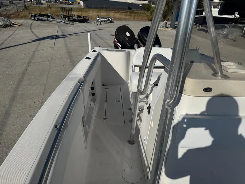Slide: The Image of 2005 Sea Chaser 2600 CC boat deck with railing and dual outboard motors. - 7
