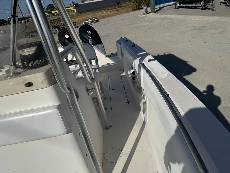 Slide: The Image of 2005 Sea Chaser 2600 CC boat interior, showing deck and seating area in sunlight. - 8