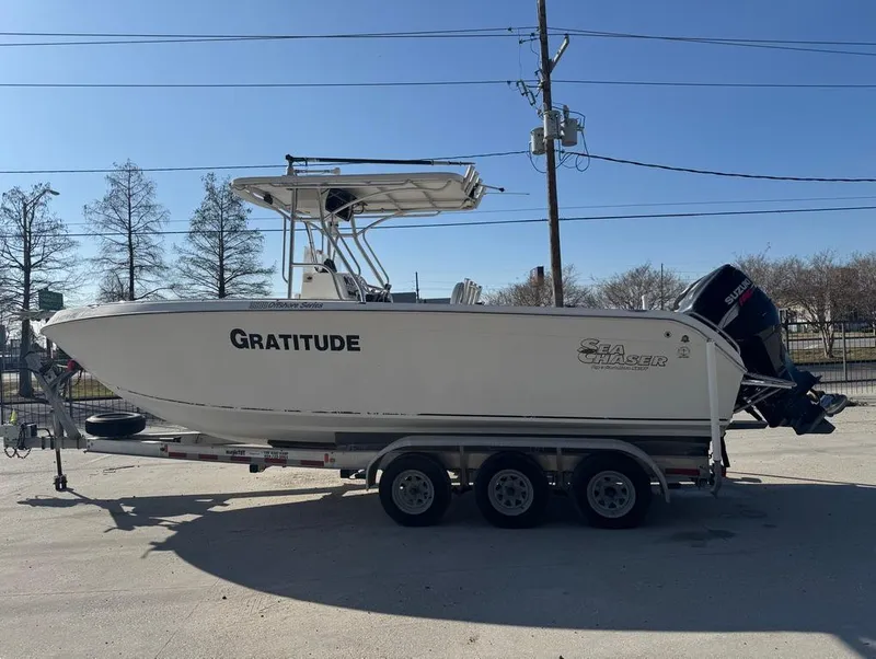 Slide: The Image of 2005 Sea Chaser 2600 CC boat on trailer, labeled "Gratitude," parked outdoors. - 9