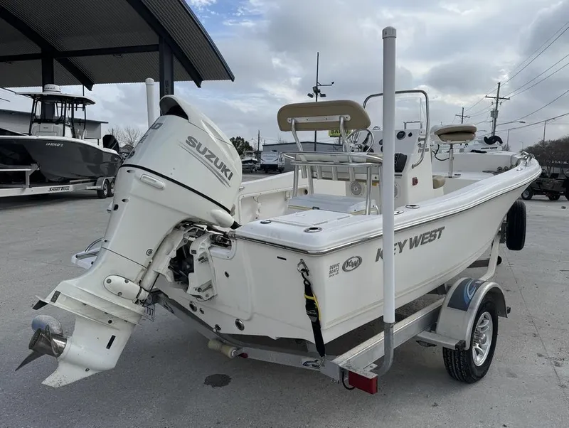 Slide: The Image of 2017 Key West 176cc boat with Suzuki outboard motor on a trailer. - 10