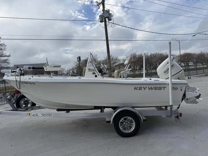 Slide: The Image of 2017 Key West 176cc boat on trailer, parked outdoors under cloudy sky. - 5