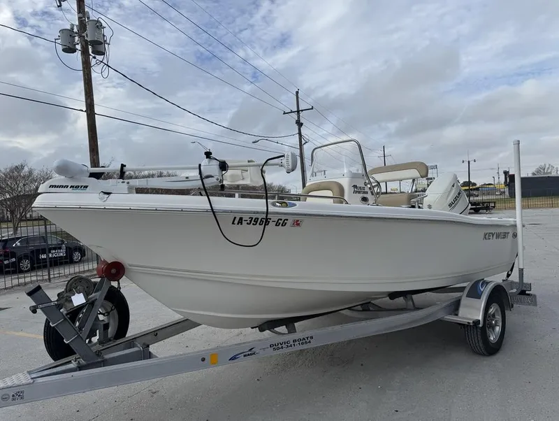 Slide: The Image of 2017 Key West 176cc boat on trailer, parked outdoors under cloudy sky. - 6