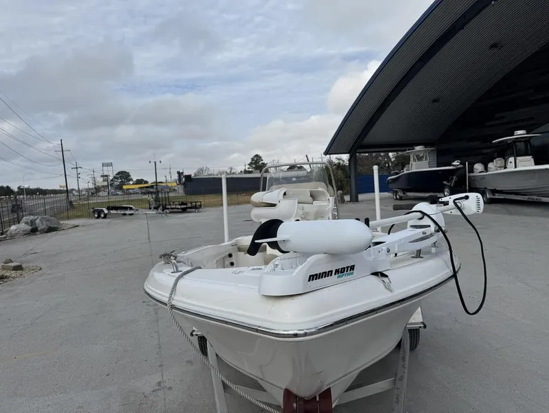 Slide: The Image of 2017 Key West 176cc boat with Minn Kota motor, parked outdoors. - 7