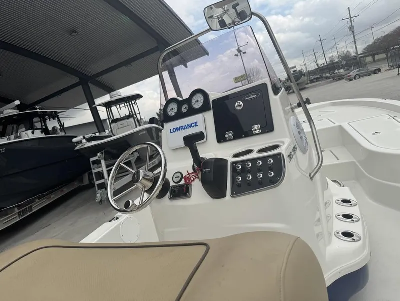 Slide: The Image of 2019 NauticStar 215 XTS boat dashboard with steering wheel and controls. - 7