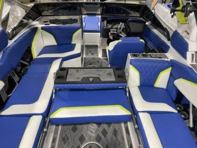 Slide: The Image of 2024 Tigé 24RZX boat interior with blue and white seating, modern design, and spacious layout. - 6