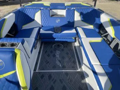 Slide: The Image of 2024 Tigé 24RZX boat interior with blue and white seating, lime accents. - 7