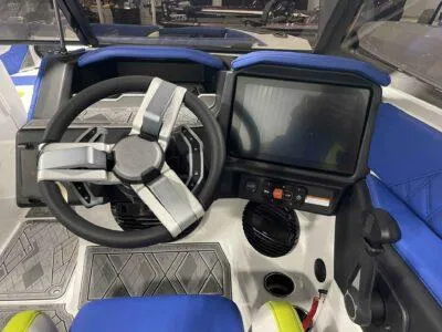Slide: The Image of 2024 Tigé 24RZX boat dashboard with steering wheel and touchscreen display. - 8